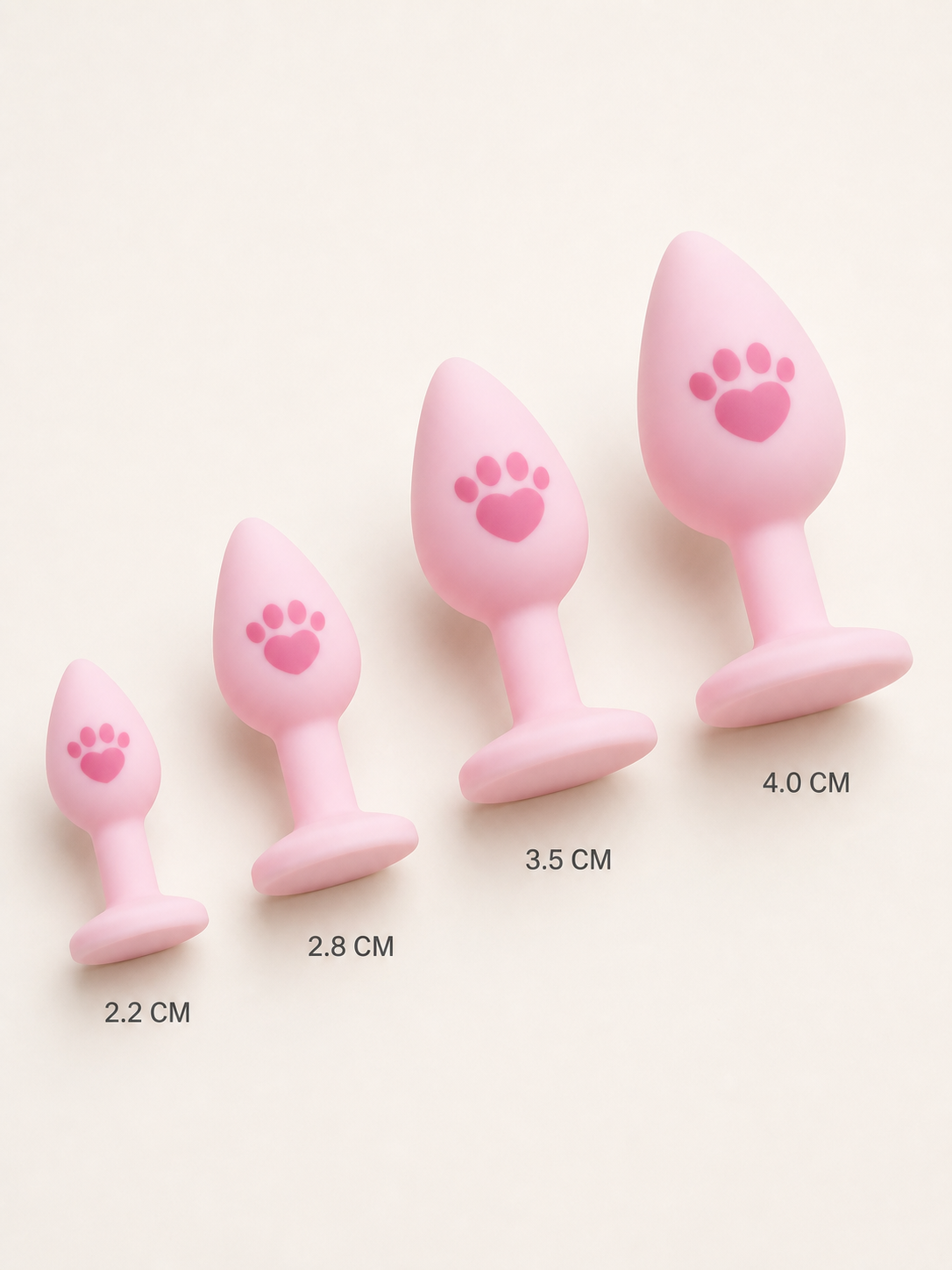 Four pink silicone tail plugs in angled size progression