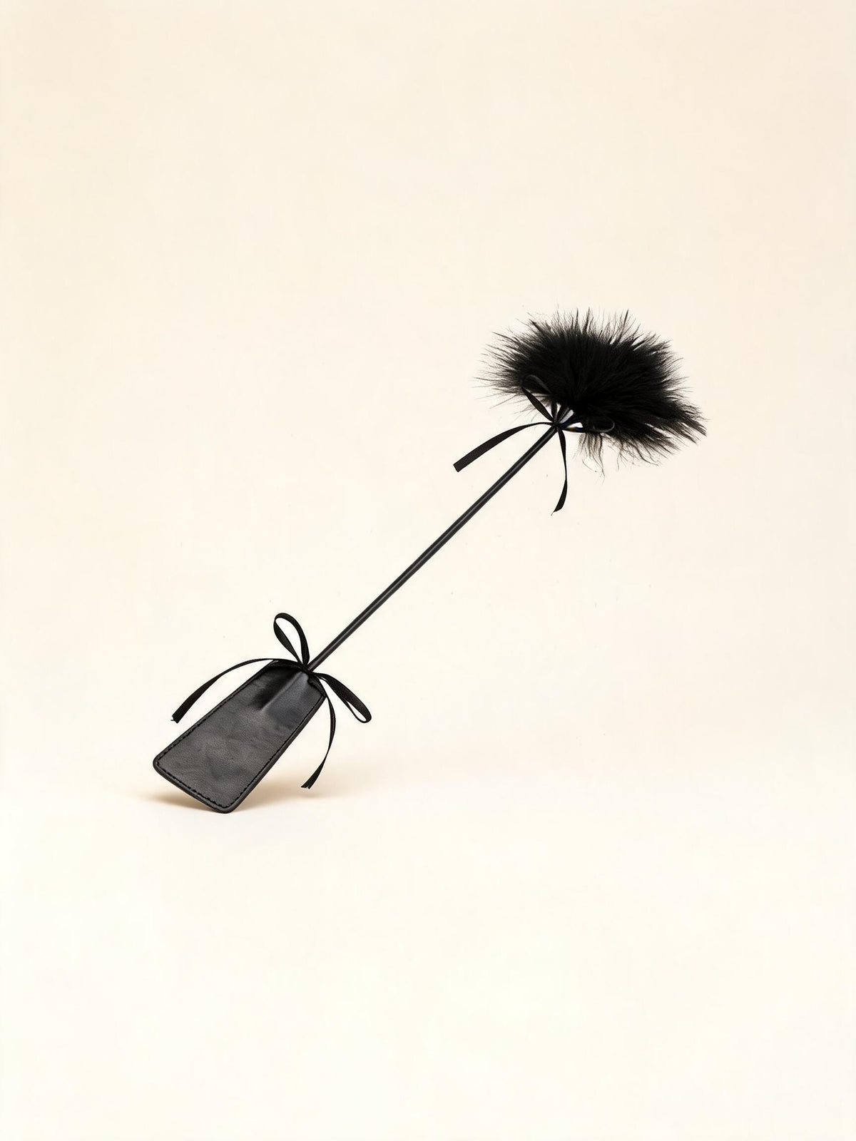Long black feather tickler wand with paddle handle — high-resolution product view